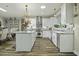 Modern kitchen with white cabinets, granite counters, and an island at 3034 Cane Slash Rd, Johns Island, SC 29455