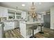 Modern kitchen with white cabinets, granite counters, and an island at 3034 Cane Slash Rd, Johns Island, SC 29455