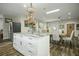 Large kitchen island with granite countertop and white cabinets at 3034 Cane Slash Rd, Johns Island, SC 29455