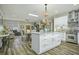 Modern kitchen with island, white cabinets, and stainless steel appliances at 3034 Cane Slash Rd, Johns Island, SC 29455