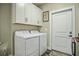 Bright laundry room with washer, dryer, and extra storage at 3034 Cane Slash Rd, Johns Island, SC 29455