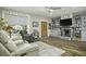 Cozy living room features a fireplace, built-in shelving, and comfortable seating at 3034 Cane Slash Rd, Johns Island, SC 29455