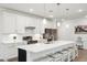 Modern kitchen with white cabinets, stainless steel appliances, and a large island at 310 Autumn Azalea Way, Summerville, SC 29486