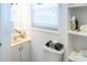 Clean bathroom with toilet, sink, and built-in shelving at 3611 Yacht Club Rd # B, Edisto Island, SC 29438