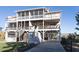 Three-story beach house with multiple decks and a paved driveway at 3611 Yacht Club Rd # B, Edisto Island, SC 29438
