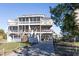 Three-story beach house with multiple decks and a paved driveway at 3611 Yacht Club Rd # B, Edisto Island, SC 29438