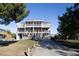 Three-story beach house with multiple decks and a paved driveway at 3611 Yacht Club Rd # B, Edisto Island, SC 29438