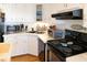 L-shaped kitchen with white cabinets, and stainless steel appliances at 3611 Yacht Club Rd # B, Edisto Island, SC 29438