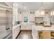 Spacious kitchen with marble island, stainless steel appliances, and white shaker cabinets at 39 Isle Of Hope Rd, Mount Pleasant, SC 29464