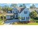 Two-story light blue house with gray roof, shutters, and porch at 4023 Cascades Thrust, Summerville, SC 29483