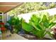 Landscaped backyard with a water feature and large tropical plants at 404 Claymoor Village Ln, Summerville, SC 29486