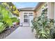 Private backyard patio with lush tropical plants and storage shed at 404 Claymoor Village Ln, Summerville, SC 29486