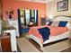 Spacious bedroom with coral-colored bedding and a rustic white dresser at 404 Claymoor Village Ln, Summerville, SC 29486