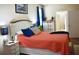 Bright bedroom with coral bedding, white dresser, and ensuite bathroom at 404 Claymoor Village Ln, Summerville, SC 29486