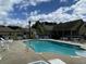 Inviting community pool with ample seating and surrounding landscape at 404 Claymoor Village Ln, Summerville, SC 29486