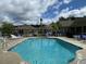 Inviting community pool with ample seating and surrounding landscape at 404 Claymoor Village Ln, Summerville, SC 29486