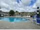 Inviting community pool with lounge chairs, tables, and umbrellas at 404 Claymoor Village Ln, Summerville, SC 29486
