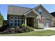 Landscaped yard with a spacious two-car garage and a welcoming porch at 404 Claymoor Village Ln, Summerville, SC 29486