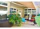 Relaxing patio with covered awning, comfortable seating, and lush tropical plants at 404 Claymoor Village Ln, Summerville, SC 29486