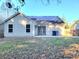 Rear view of house with solar panels and fenced backyard at 5133 Ballantine Dr, Summerville, SC 29485