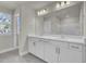 Double vanity bathroom with white cabinets and a large mirror at 5629 Ellington School Rd, Ravenel, SC 29470
