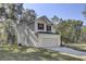 Gray-sided house with black shutters, gray roof, and a two-car garage at 5629 Ellington School Rd, Ravenel, SC 29470
