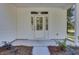 White front door with glass panels and a covered porch at 5629 Ellington School Rd, Ravenel, SC 29470