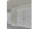 Hallway with grey carpet, neutral walls, and two white doors leading to other rooms at 5629 Ellington School Rd, Ravenel, SC 29470