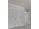 Hallway with grey carpet, neutral walls, and two white doors leading to other rooms at 5629 Ellington School Rd, Ravenel, SC 29470