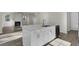 Modern kitchen with island, stainless steel appliances, and hardwood floors at 5629 Ellington School Rd, Ravenel, SC 29470