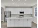 Large kitchen island with white cabinets and quartz countertop at 5629 Ellington School Rd, Ravenel, SC 29470