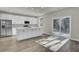 Modern kitchen with white cabinets, stainless steel appliances, and island at 5629 Ellington School Rd, Ravenel, SC 29470