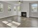 Spacious living room with hardwood floors, a fireplace, and lots of natural light at 5629 Ellington School Rd, Ravenel, SC 29470