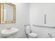 Clean bathroom with pedestal sink, toilet, and grab bars at 6261 Gritman Dr, Hollywood, SC 29470