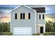 Two-story home with gray siding, black shutters, and a two-car garage at 6261 Gritman Dr, Hollywood, SC 29470
