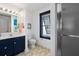 Navy blue vanity, toilet, and shower in a small bathroom at 780 Post Oak Dr, Mount Pleasant, SC 29464