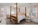 Charming bedroom with a wooden four-poster bed and pink accents at 780 Post Oak Dr, Mount Pleasant, SC 29464