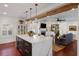 Modern kitchen with white cabinets, marble island, and a view of the living room at 780 Post Oak Dr, Mount Pleasant, SC 29464