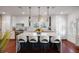 Modern kitchen with white cabinets, marble island, and hardwood floors at 780 Post Oak Dr, Mount Pleasant, SC 29464