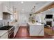 Open kitchen with white cabinets, marble island, and view to living area at 780 Post Oak Dr, Mount Pleasant, SC 29464