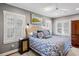 Spacious main bedroom with a blue and white comforter, and hardwood floors at 780 Post Oak Dr, Mount Pleasant, SC 29464