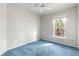 Empty bedroom with blue carpet, window, and neutral walls at 904 W Marymont Ln, Charleston, SC 29414