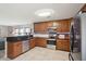 Modern kitchen with stainless steel appliances and dark wood cabinets at 1038 Briar Rose Ln, Ladson, SC 29456