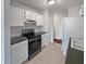 Kitchen with white cabinets, black appliances, and tile floors at 113 Evergreen Magnolia Ave, Goose Creek,  29445