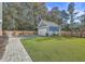 Landscaped backyard with a large lawn and a detached garage at 119 Germantown Rd, Summerville,  29483