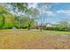 Large backyard with mature trees and patio at 185 Old Fort Dr, Ladson, SC 29456