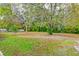 Large backyard with mature trees and grassy areas at 185 Old Fort Dr, Ladson, SC 29456