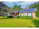 Brick ranch home with solar panels, large yard, and covered porch at 185 Old Fort Dr, Ladson, SC 29456
