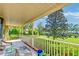 Relaxing front porch with white railings, overlooking a lush green yard at 185 Old Fort Dr, Ladson, SC 29456