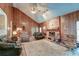 Spacious living room with vaulted ceilings, brick fireplace, and wood paneling at 185 Old Fort Dr, Ladson, SC 29456